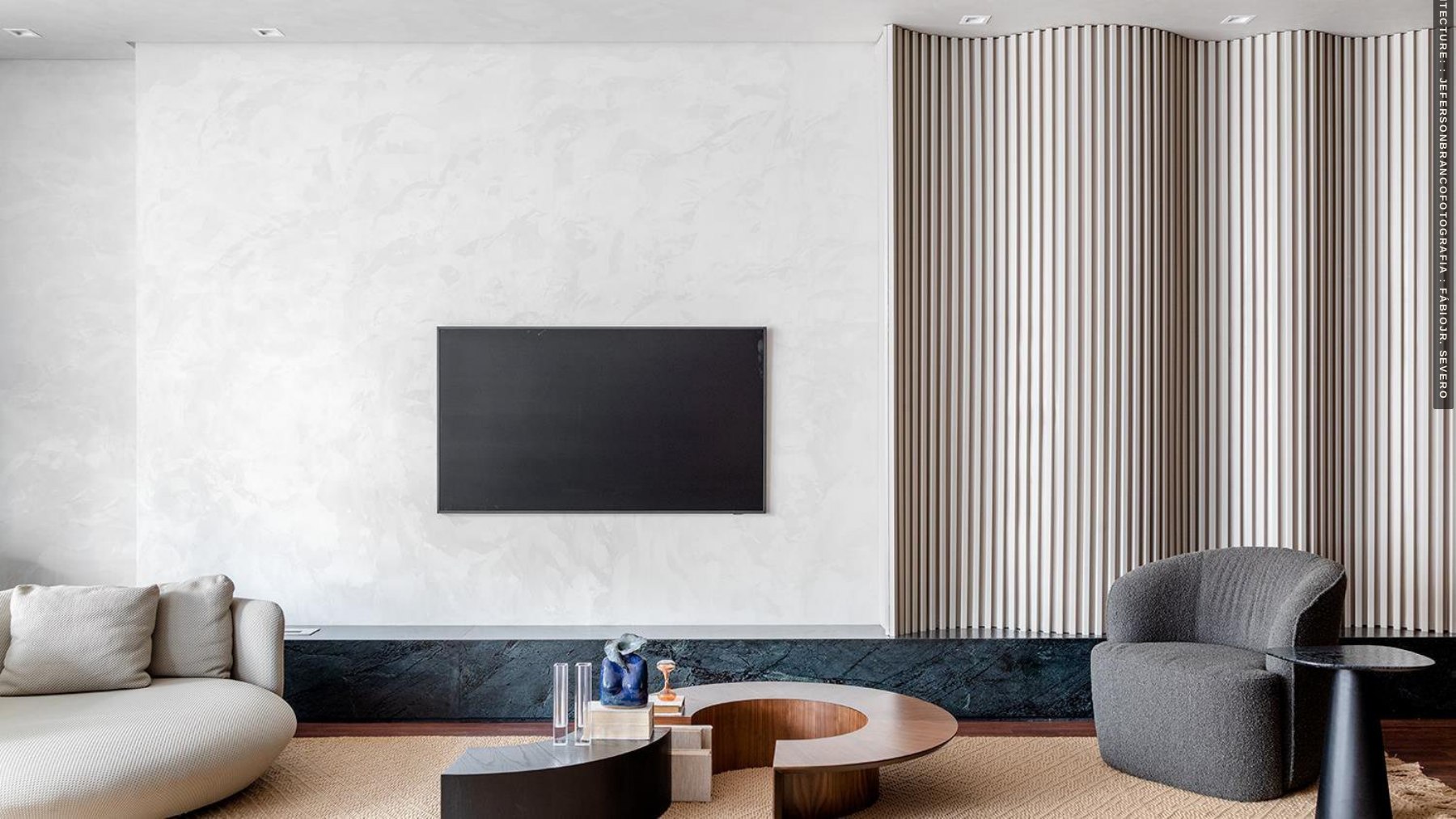 Living space with a pale media wall and fireplace
