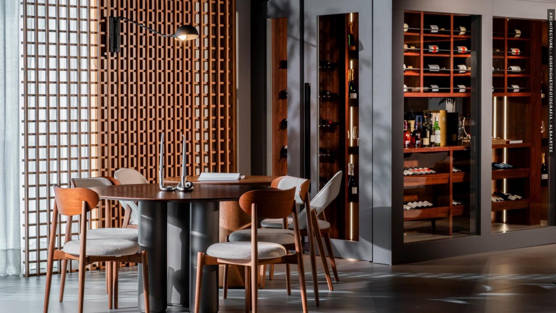 Decorative wood screen beside a kitchen and dining area