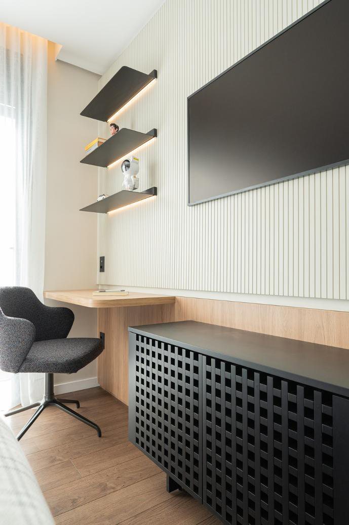 Integrated desk with floating shelves beside a window